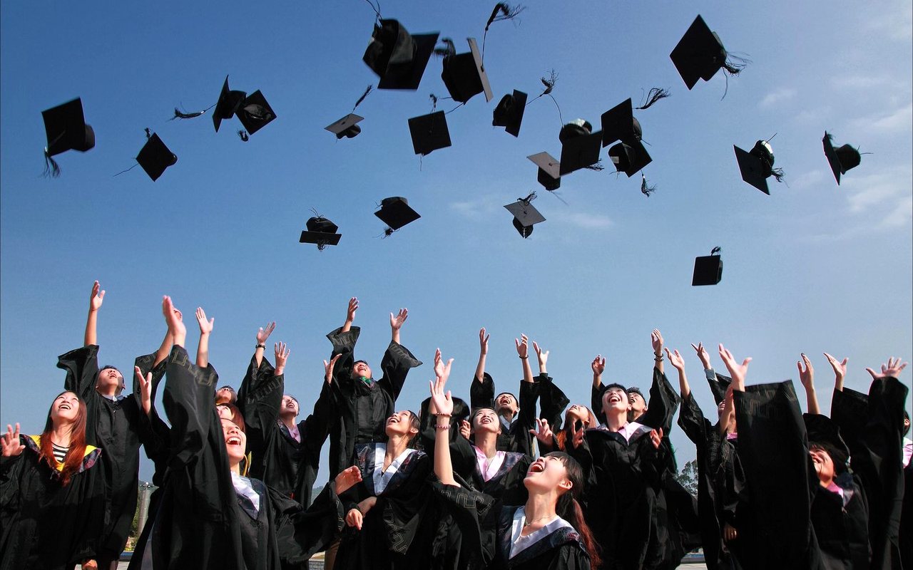 Graduates tossing caps in the air on commencement day